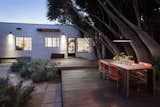 Raised deck with exterior dining terrace at dusk