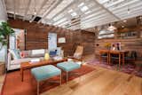 Living Room looking East towards bedrooms and bathroom hidden behind reclaimed wood siding clad walls