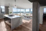 Kitchen, Marble Backsplashe, Wood Cabinet, Marble Counter, Medium Hardwood Floor, Pendant Lighting, Refrigerator, Wall Oven, Cooktops, Dishwasher, and Undermount Sink Kitchen island, Living Room and Study from entry with panoramic views of Los Angeles beyond  Photos from LFT Residence