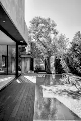 Swimming pool with raised wood deck at Living Room threshold (left).