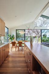 Kitchen with American black walnut cabinetry including walnut cabinet pulls, knobs and countertop at island complimented with smoked oak floors by Shengaris