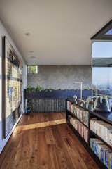 Top of stairs:  A custom cold rolled steel guardrail that also acts as hanging garden planter with integral french drain system within. To the right there is a built-in window seat that overlooks the mountains and valley beyond.  This passage leads the primary suite.