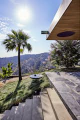 The local wildlife's watering hole!
The roof overhang with a white oak lid extends from the living room to the exterior as the flagstone flooring continues to the outside as well. An oculus gives a peek to the garden roof from below. A brass scupper stretches to throw excess irrigation water of the above roof garden to a circular, steel catch basin that rises above the no-mow fescue grass of the hillside. Concrete steps lead to the garage at the lower level. The glory of the canyon and Fossil Ridge Park is seen beyond. 