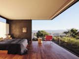 For the primary bedroom, widescreen glass walls frame the valley, mountains, ridge tops and trees beyond.  Privacy expressed in an updated mid-century modern design language. Stucco walls from the exterior extend inside. Planted garden roof insulates the living room below.  Clerestory windows complete the pavilion feel.