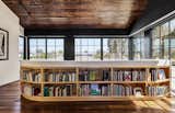 Reading Room with library wrapping plaster guardrail opens to outdoor living room balcony with fireplace