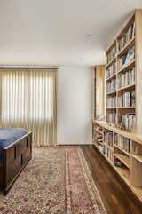 Primary Bedroom with built-in birch cabinetry for library symmetrically formed around the windows