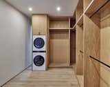 A common feature we've designed in recent years in a secondary laundry in the primary closet: This one outfitted with the latest stackable LG washer and dryer. Deep recess for window beyond in this 10-foot tall, bespoke white oak cabinetry enclave