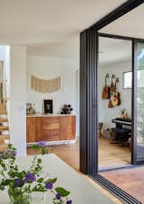 Family playroom is part music room and part bar adjacent to outdoor dining and kitchen