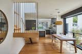 Centrally located stair cascades into the kitchen which is open to a covered outdoor dining deck and backyard 