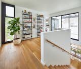 Top of stair opens to a landing homework / desk / study tucked behind the stair guardrail half- wall. South-facing natural light exposure from the sliding door opening- with access to a second floor outdoor family room deck - pours into the stair below throughout the day. 