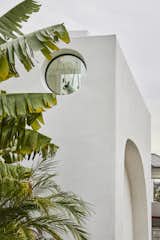 The doggie guards her palace of smooth stucco and verdant gardens from her circular window at the second floor gloriette on the edge of a hill in east Los Angeles