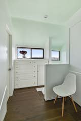 Top of the stairs with built-in dresser and countertop. Nice spot for keys, phone and wallet. This landing is the foyer for the primary suite.