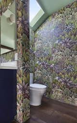 Toilet room with Cole & Son wallpaper and skylight above