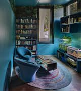 Sunken room. With outdoor access to patio and garden, the aquariums and turquoise paint set the vibe. Pierre Poulin chairs, library and Cole & Sons wallpaper...time to chill out