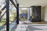 Primary Bedroom with 100-year old oak tree beyond. Swimming pool with wood deck and yard below. 