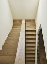 Simple wood stair with large clerestory window (brings an abundance of natural light from second floor.