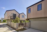 Luxury townhouses by Hsu McCullough. Two separate residence - detached with shared driveway. Modern Mill wood siding with a pale blush finish wraps the second floor exterior with Anderson windows. Smooth stucco at ground floor with each residence having it's own enclosed garden yard. Balcony denotes the primary suite.