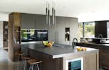 Kitchen, Concrete Counter, Wood Cabinet, Wine Cooler, Pendant Lighting, and Wall Oven Laurelhurst Residence  Photos from Quantum Clad Windows & Doors