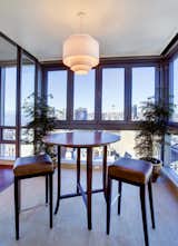 The upper windows in the sunroom accordion-fold to create an a much desired open-air feel to the space.