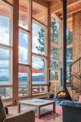 Light Hardwood Floor, Wood Burning Fireplace, Sofa, Coffee Tables, Chair, Windows, Wood, Metal, Sliding Window Type, and Picture Window Type  Photo 3 of 4 in Ferris Cabin by Patano Studio Architecure