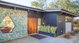 The dramatic front door made of African Mahogany is a custom component incorporated in the Clearview project. The Brown Studio, Inc. an architectural and interior design + build firm, and partner with dasMOD, offers a hand-crafted approach through their design studio and fabrication workshop.