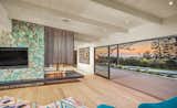 The cantilevered fireplace made with custom milled oak and Palm Springs sourced turquoise tile creates a unique centerpiece of the home.