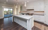 Kitchen, Medium Hardwood Floor, and White Cabinet  Photo 1 of 5 in Dynasty Partners Home by Elizabeth Bindert