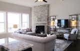 Living Room, Sofa, Ceiling Lighting, Bookcase, Dark Hardwood Floor, and Corner Fireplace  Photo 3 of 5 in Dynasty Partners Home by Elizabeth Bindert