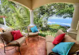 Covered terrace overlooking pool, garden, ocean