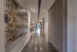 The central structural beam organizes the main circulation spine of the home.  This main pathway 
through the home is also defined by the exposed concrete flooring. 