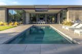Outdoor, Back Yard, Metal Patio, Porch, Deck, Desert, and Swimming Pools, Tubs, Shower Pool centered on outdoor living space and central fireplace beyond.   Photo 8 of 15 in Arroyo House by KOSS design + build