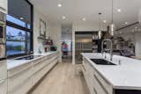 The combination of white and dark wood cabinets give the kitchen a modern but classic feel. 