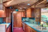 The galley kitchen in Eagles Nest has original redwood cabinets and sky blue corian counters.  Throughout both homes, square skylights (here with optional blue filters) are liberally scattered.  Look close -- all are Pyrex dishes with emblem in the center.