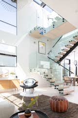 Staircase, Glass, Metal, and Wood Natural light illuminates living area.   Staircase Glass Metal Wood Photos from Milwood Residence