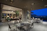 With door panels retracted, the indoor-outdoor entertaining space gains intimacy and drama as darkness illuminates distant city lights.