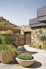 A custom gate and fencing surrounds the entry courtyard providing privacy but still allowing the space to be enhanced by the surrounding flora and rock formations. 