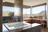 A serene soaking tub provides sanctuary while the surrounding mountains provide the view in this stunning modern residence located at the Estancia Club in north Scottsdale.
