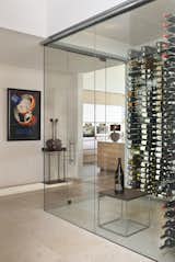 With a perfect location between the kitchen and a stunning oval office, this custom wine room houses the owners' favorite collection other than art, wine.
