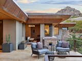 An outdoor sitting area adjacent to the master suite engages nature and the surrounding views and seamlessly connects to indoor spaces. 