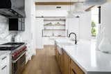 Easily camouflaged by rolling custom barn doors, the "dirty" kitchen serves as a pantry and staging area for dinner parties and includes its own sink, dishwasher and refrigerator.  
