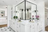 The brilliant bathroom layout provides his and her vanities, an enviable master closet, soaking tub, and shower enclosure. Marble floors and counters repeat the  theme of white walls adding texture and variation to the palette.