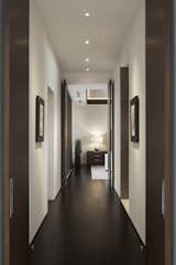 The passageway to the master bedroom is flanked by master bathroom and master closet. Custom horizontal grain rift oak doors are stained to match the African Mahogany flooring