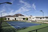 A private tennis court flanks the north side of White Box No. 2, with a stunning view of Camelback Mountain beyond. 
