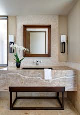 A custom-designed Nacarado Quartzite vanity and metal sink create a not-to-be-forgotten
powder room.