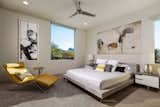 A guest bedroom features a stunning Camelback Mountain view, modern art, and pops of bright color in a nod to the mid-century modern styling popularized in the '50s.