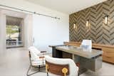 The office becomes private via a rolling panel door. Rear outdoor living areas are visible and just a few steps away. 