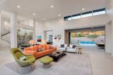 A chartreuse Platner chair; a low-profile, linear orange sofa; and a pair of simple taupe-colored side chairs with wood frames are indicative of the era when post-and-beam construction gave way to open spaces and pops of color were highlights of interiors. -- Phoenix Home and Garden, May 2016