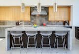 A large airy kitchen, with wire-brushed oak cabinets topped with Caesarstone provides a  modern and refreshing setting for food and friends. 