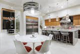 and chairs and a quartet of Bertoia bar stools provide midcentury modern touches in a "this-century" modern house. 
