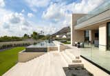 The backyard exudes a contemporary zen-like vibe with its linear pool and limestone stairway reminiscent of pyramid-style steps. A glassed-in second-floor patio offers mountain views.

Project Details // Now and Zen
Renovation, Paradise Valley, Arizona
Architecture: Drewett Works
Builder: Brimley Development
Interior Designer: Ownby Design
Photographer: Dino Tonn
Exterior limestone: Solstice Stone
Windows (Arcadia): Elevation Window & Door

https://www.drewettworks.com/now-and-zen/